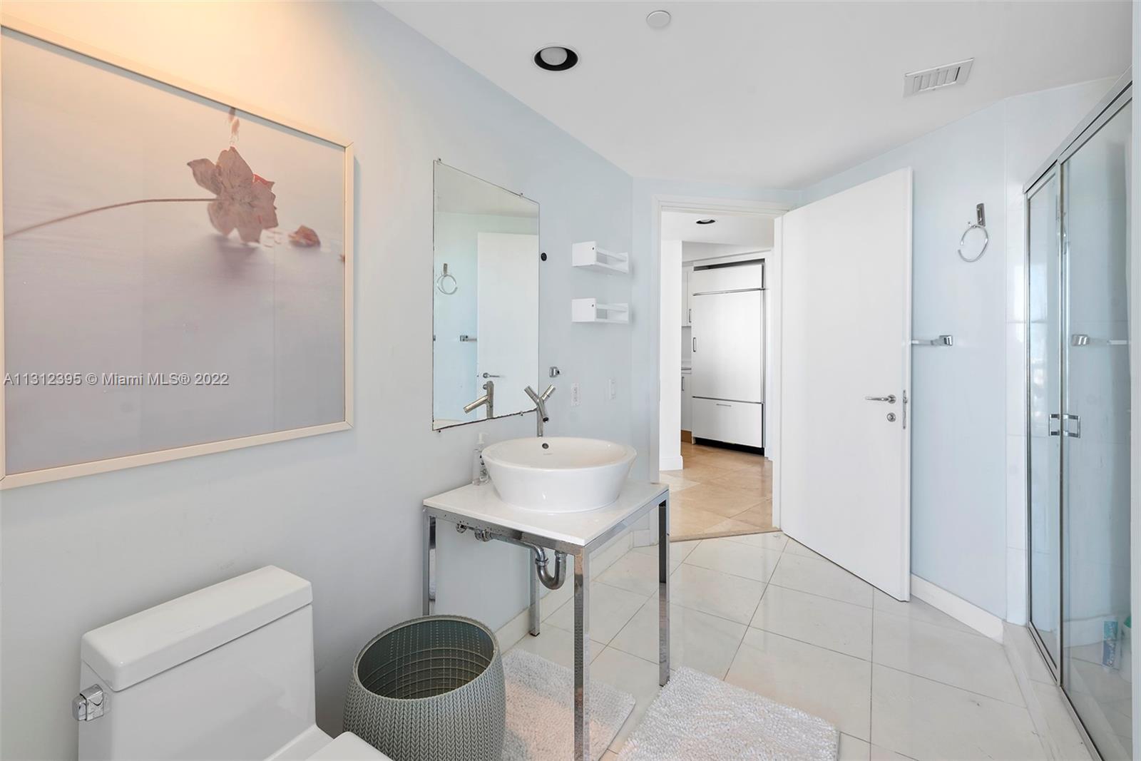 450 Alton Road, Unit 3010 Miami Beach, FL 33139 - Photo 33 of 66 a bathroom with a sink toilet and shower