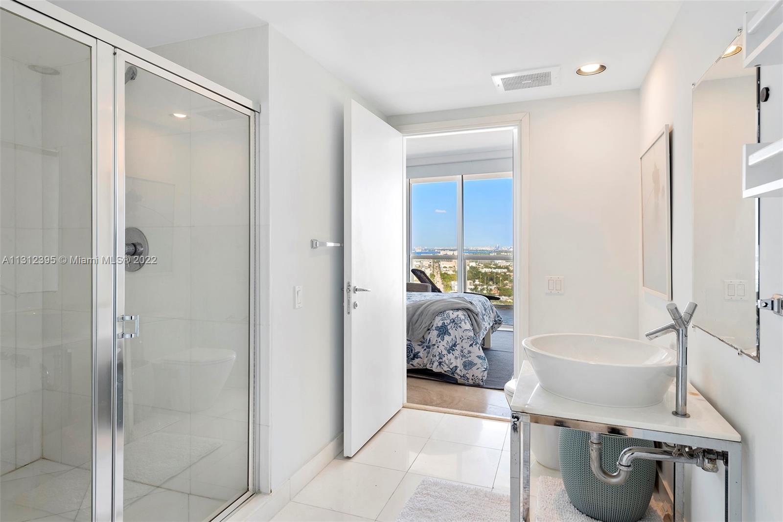 450 Alton Road, Unit 3010 Miami Beach, FL 33139 - Photo 34 of 66 a en suite bathroom with a bathtub and a shower