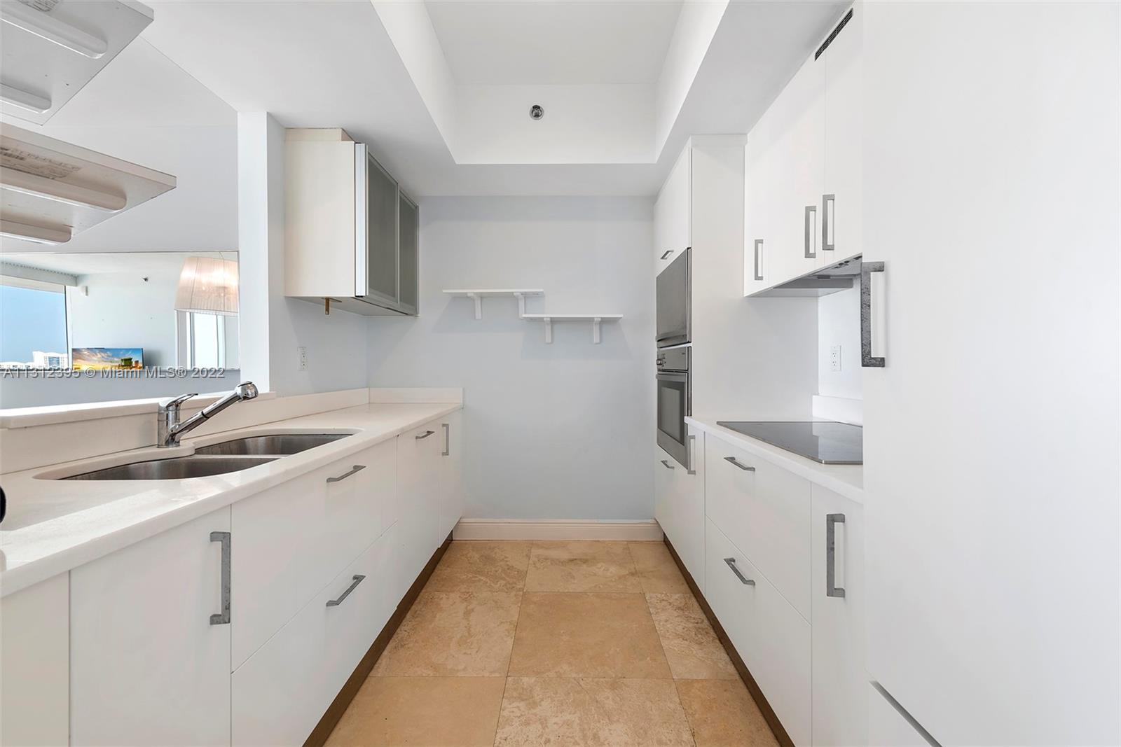 450 Alton Road, Unit 3010 Miami Beach, FL 33139 - Photo 35 of 66 a kitchen with cabinets and sink