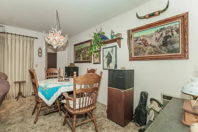 a living room with furniture a piano and a window