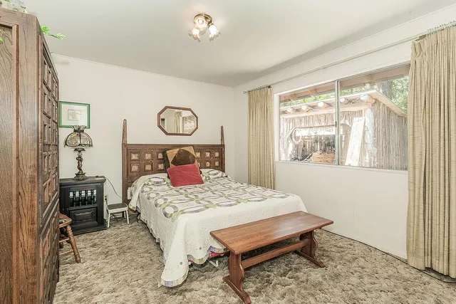 a bedroom with a bed and a table in it