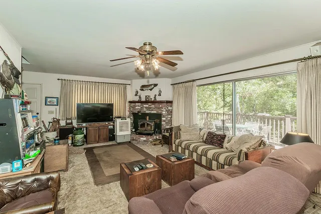 a living room with furniture a large window and a flat screen tv