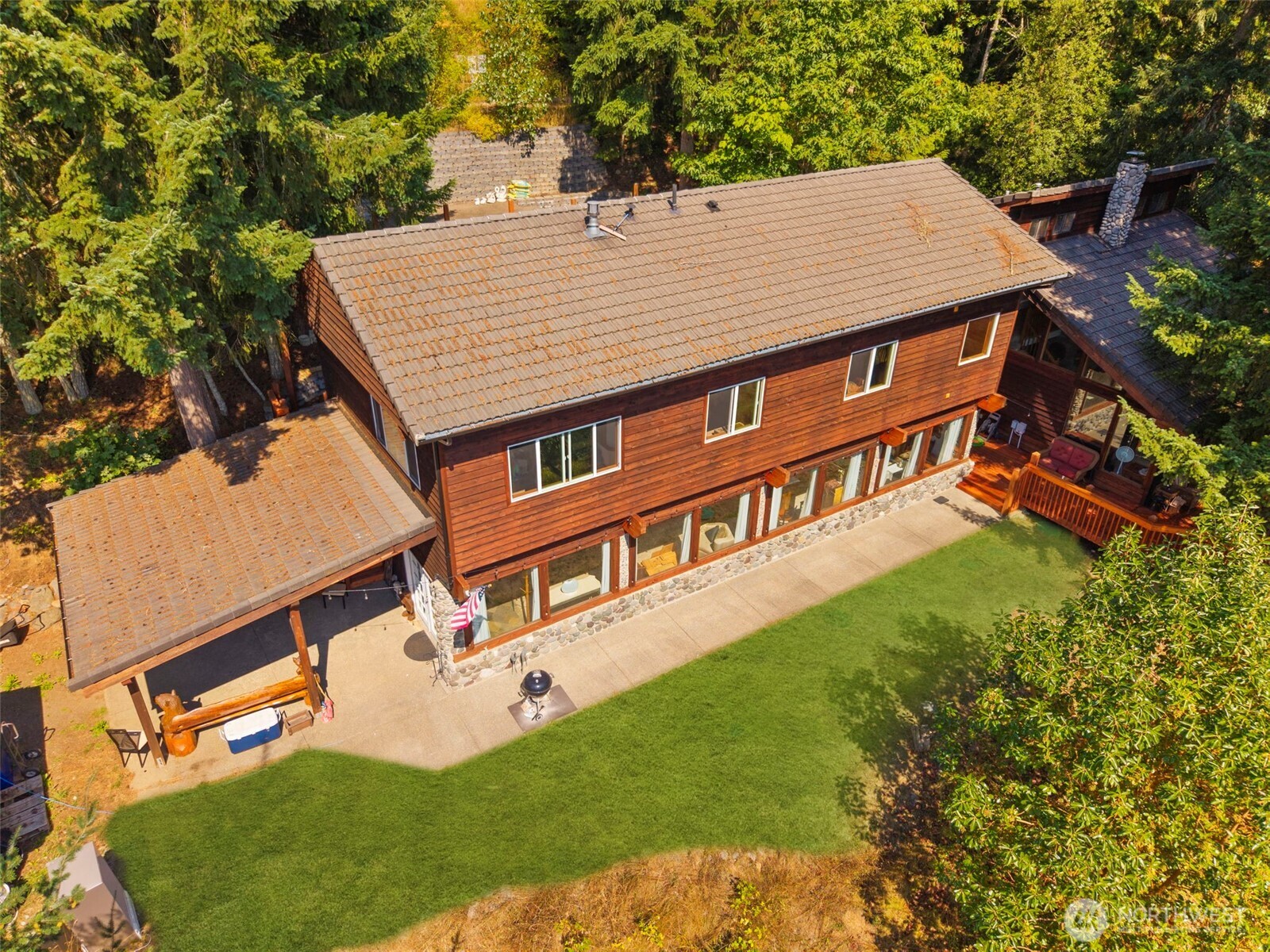 an aerial view of a house with a yard table and chairs