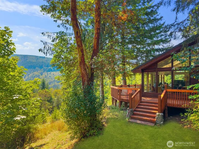 a front view of a house with garden and sitting area