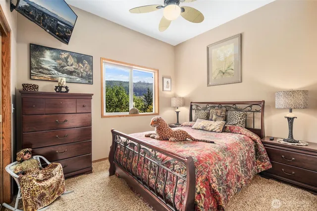 a bedroom with a bed and a chandelier