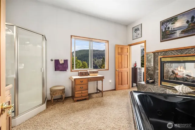a bedroom with a bed window and a flat screen tv