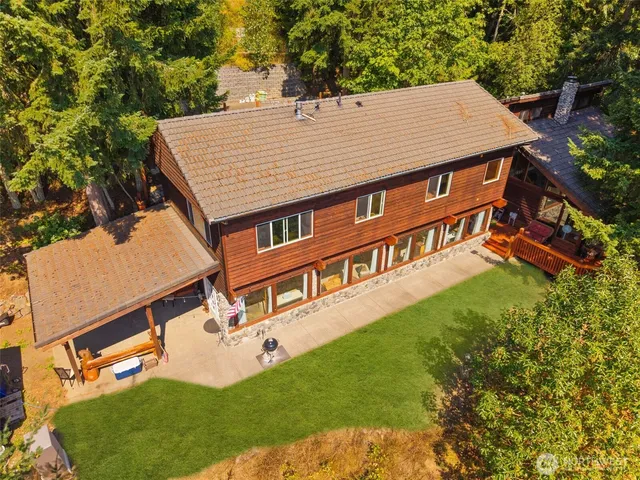 an aerial view of a house with a yard table and chairs