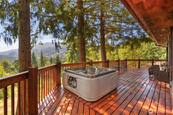 a view of a balcony with wooden floor and fence
