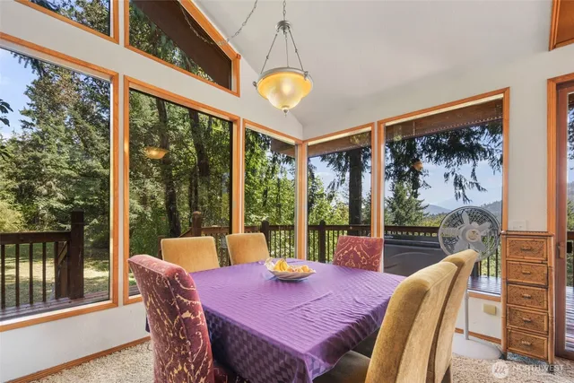 a view of a dining room with furniture a chandelier and wooden floor
