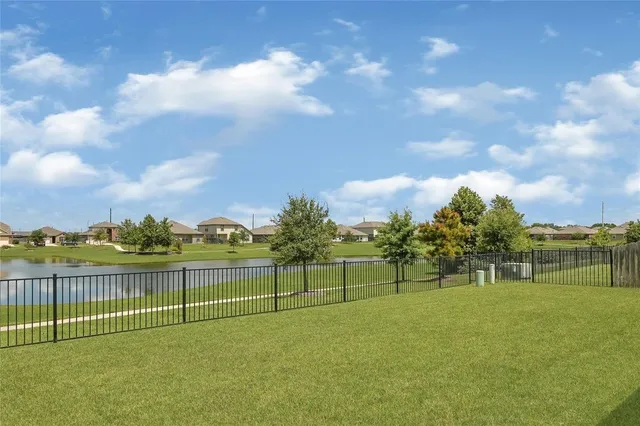 a front view of house with yard barbeque and outdoor seating