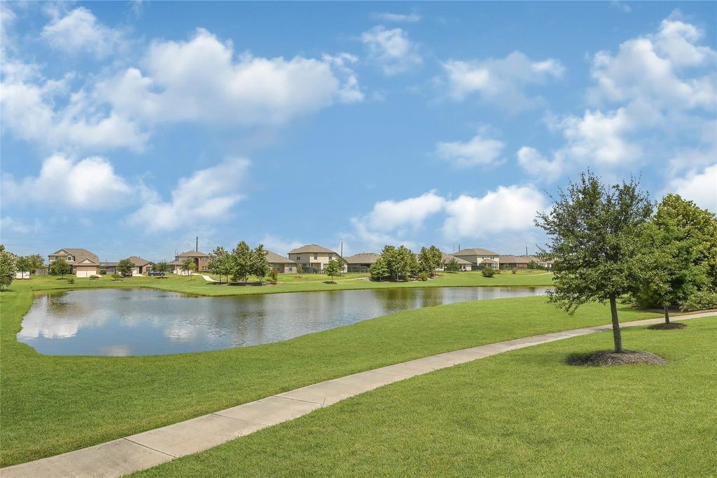 5422 Still Creek Ranch Drive Richmond, TX 77469 - Photo 25 of 28 a view of a lake with houses in the back