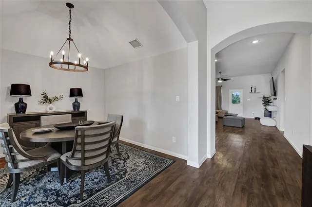 a view of a dining room with furniture wooden floor and chandelier