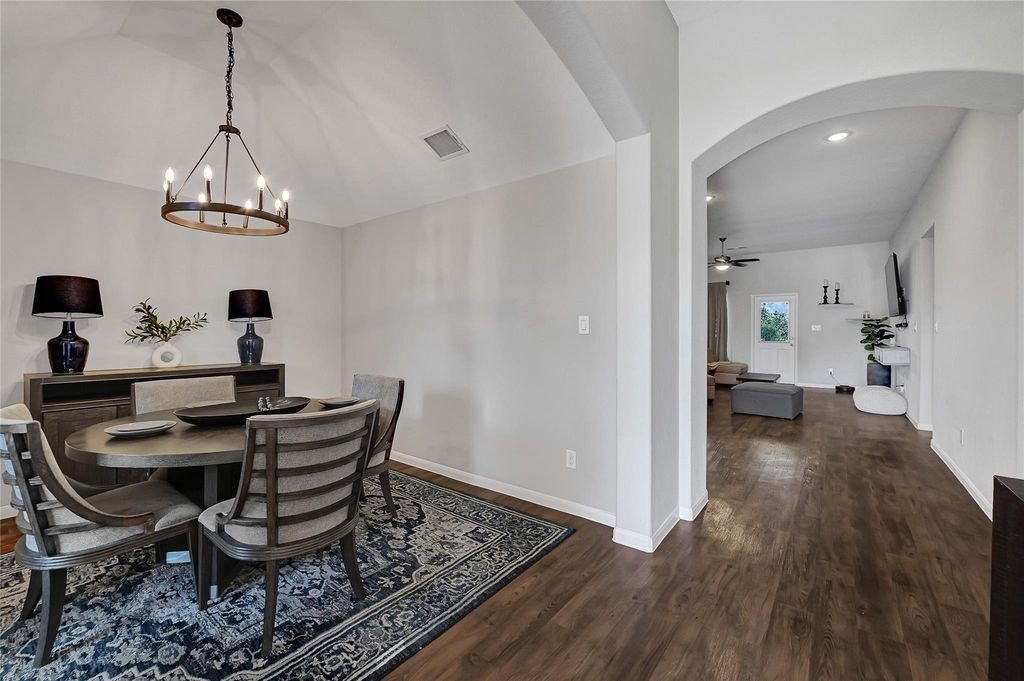 5422 Still Creek Ranch Drive Richmond, TX 77469 - Photo 5 of 28 a view of a dining room with furniture wooden floor and chandelier