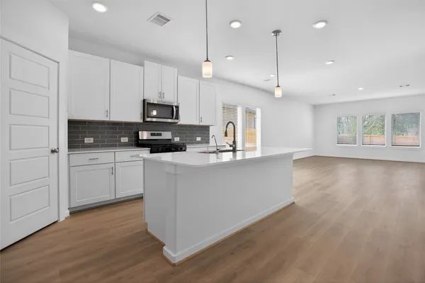 a spacious bedroom with a bed and a couch