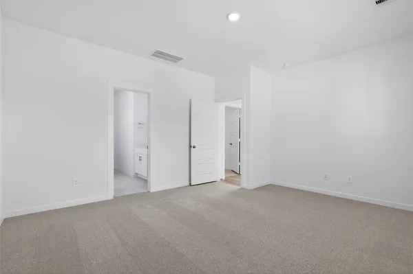 a kitchen with a sink stove and wooden floor