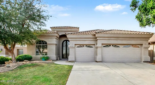 a view of a white house with a outdoor space