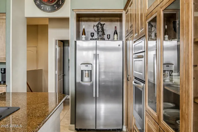 a kitchen with a stove a faucet cabinetry a sink and dining table