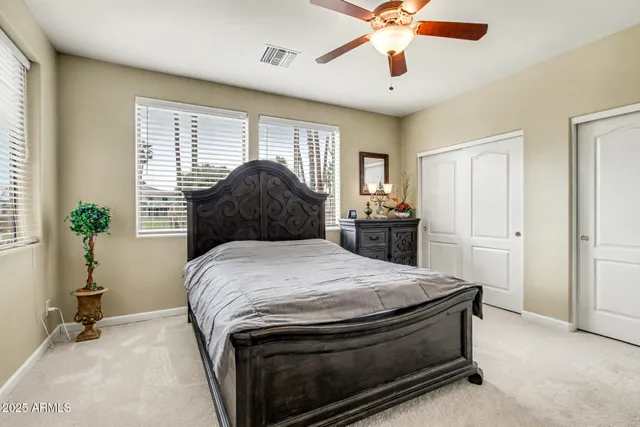 a bedroom with a bed and cabinets