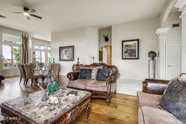 a living room with furniture a flat screen tv and a large window