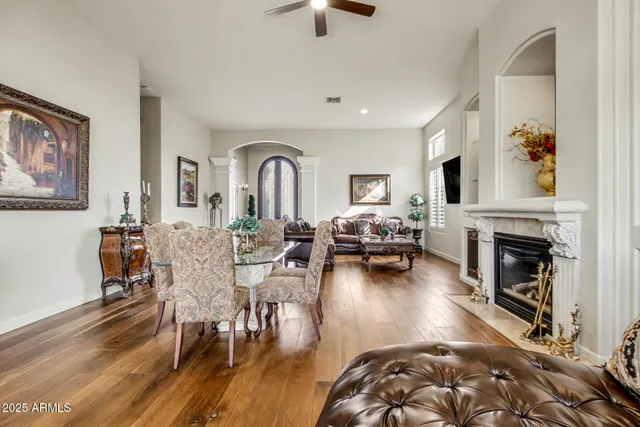 a view of a fountain in front of a house with a big yard