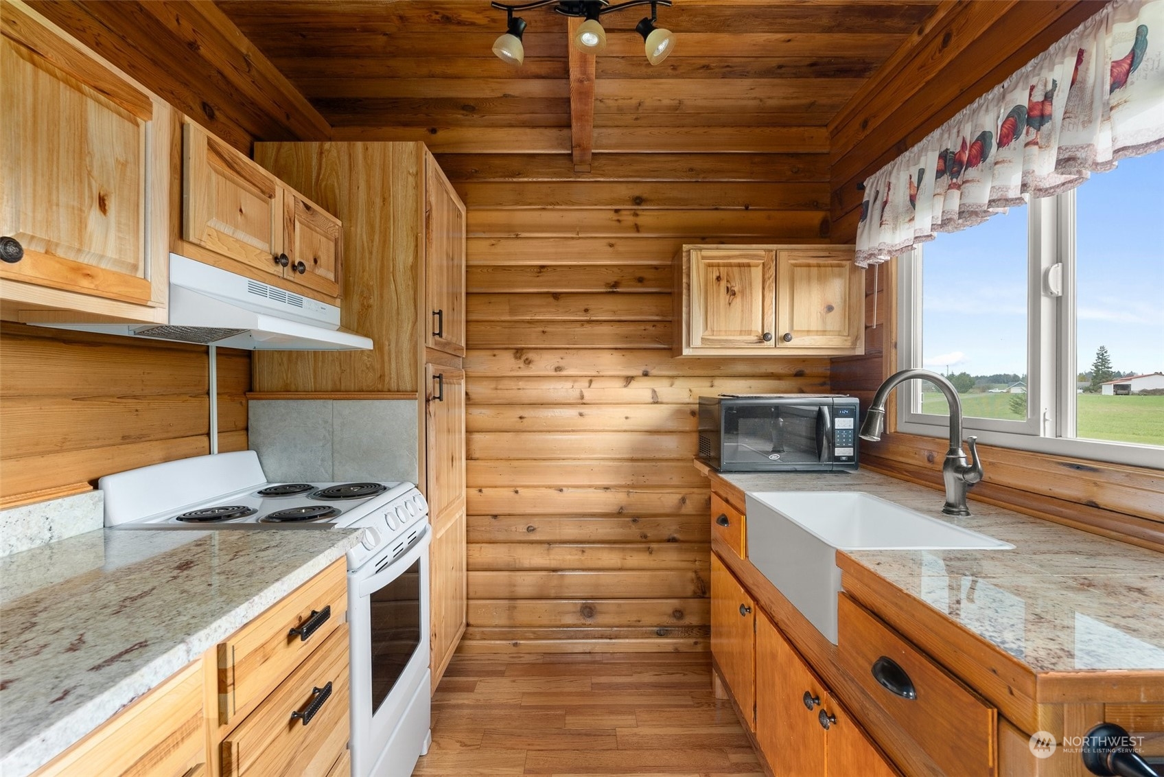 658 Spencer Road Toledo, WA 98591 - Photo 6 of 33 a kitchen with granite countertop wooden cabinets and a stove top oven