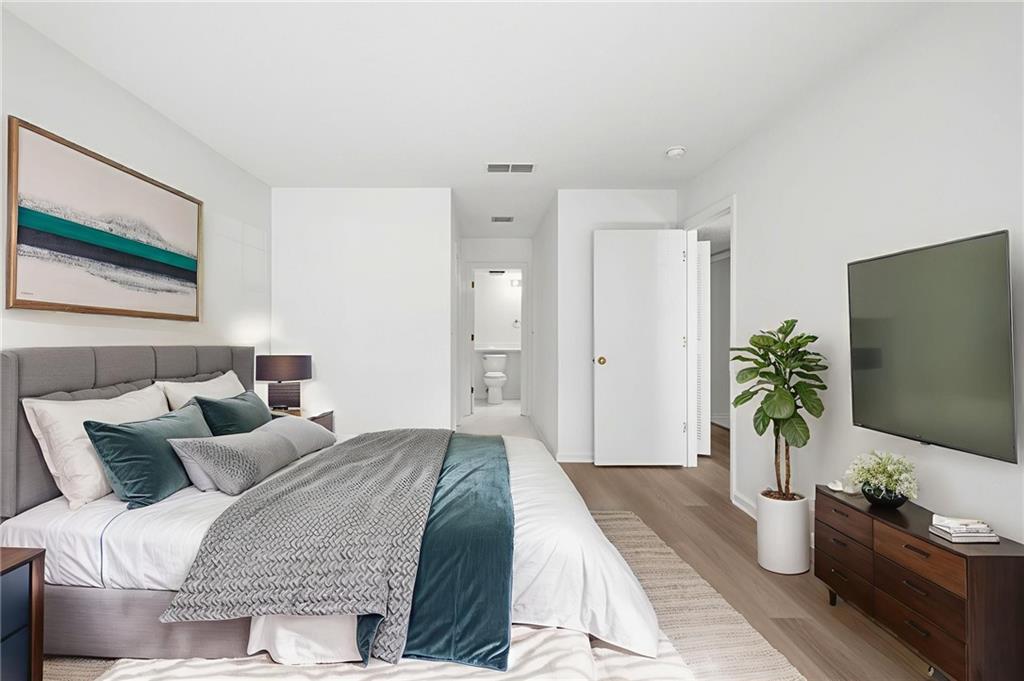 4053 Whitehall Way Alpharetta, GA 30004 - Photo 20 of 28 a bedroom with furniture and a potted plant