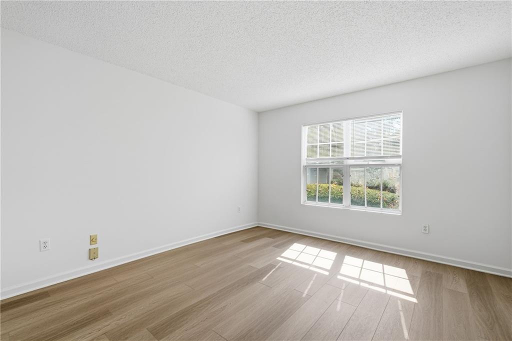 4053 Whitehall Way Alpharetta, GA 30004 - Photo 22 of 28 an empty room with wooden floor and windows