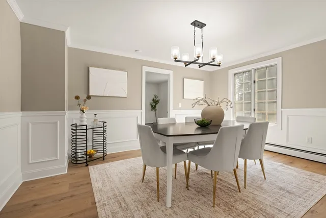 a view of a dining room with furniture window and wooden floor