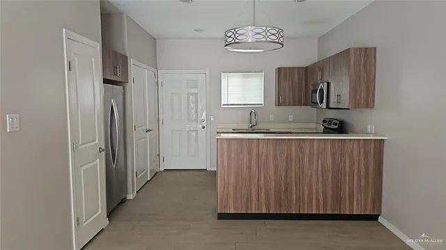 a view of a kitchen with a sink and dishwasher cabinet