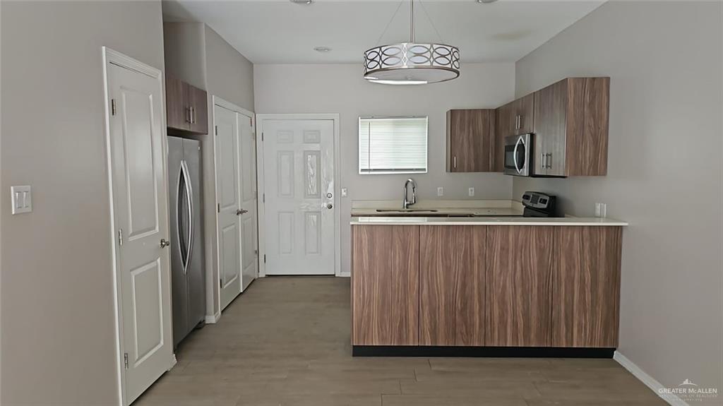 1900 Jackson Street, Unit 4 Weslaco, TX 78599 - Photo 3 of 15 a view of a kitchen with a sink and dishwasher cabinet