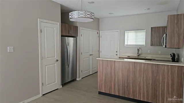 a view of a kitchen from a hallway