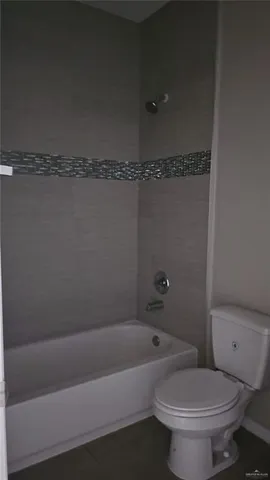 a bathroom with a toilet and a bathtub