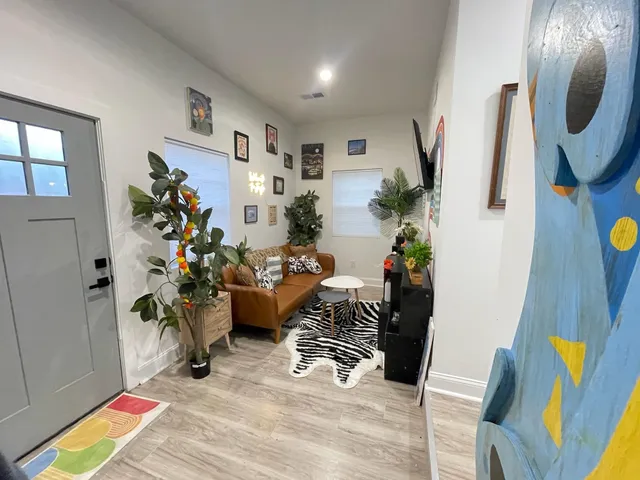 a bedroom with a bed and painting on the wall