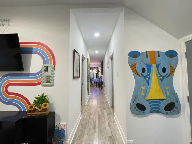 a bedroom with two beds and a potted plant