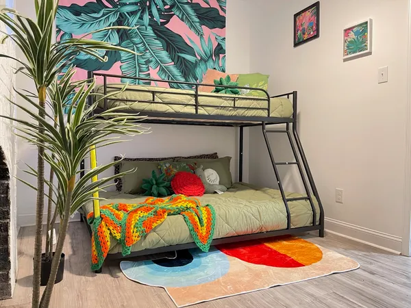 a bed sitting in a bedroom next to a window