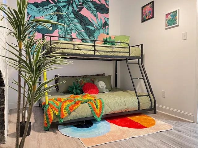 a bed sitting in a bedroom next to a window