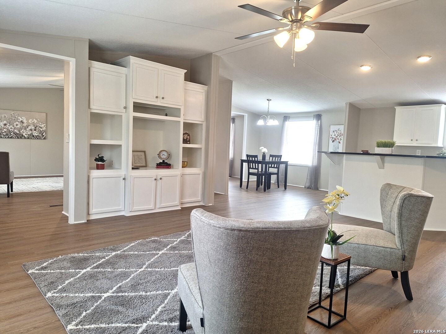 533 Las Hadas Spring Branch, TX 78070 - Photo 2 of 16 a living room with couches and kitchen view with wooden floor