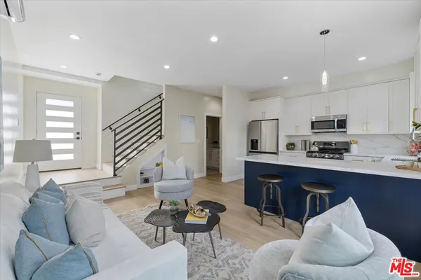 a living room with furniture kitchen and a table