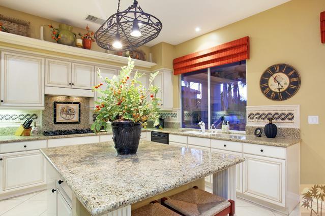 384 Loch Lomond Road Rancho Mirage, CA 92270 - Photo 12 of 25 a kitchen with a stove and a wooden cabinets