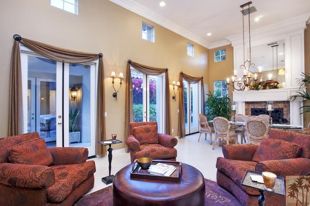 384 Loch Lomond Road Rancho Mirage, CA 92270 - Photo 6 of 25 a living room with furniture fireplace and a chandelier