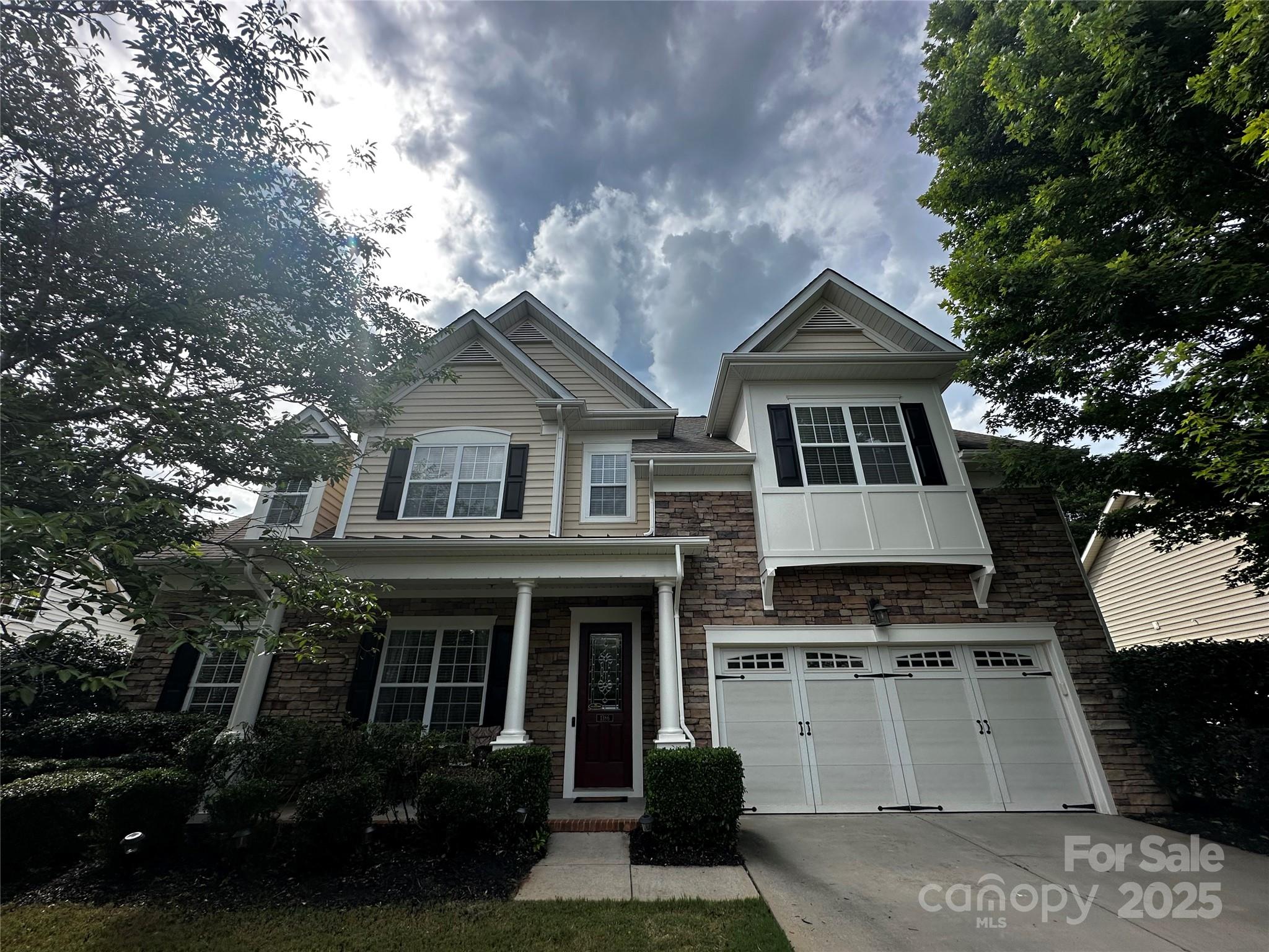 1386 Secret Path Drive Fort Mill, SC 29708 - Photo 1 of 1 a front view of a house with a garden