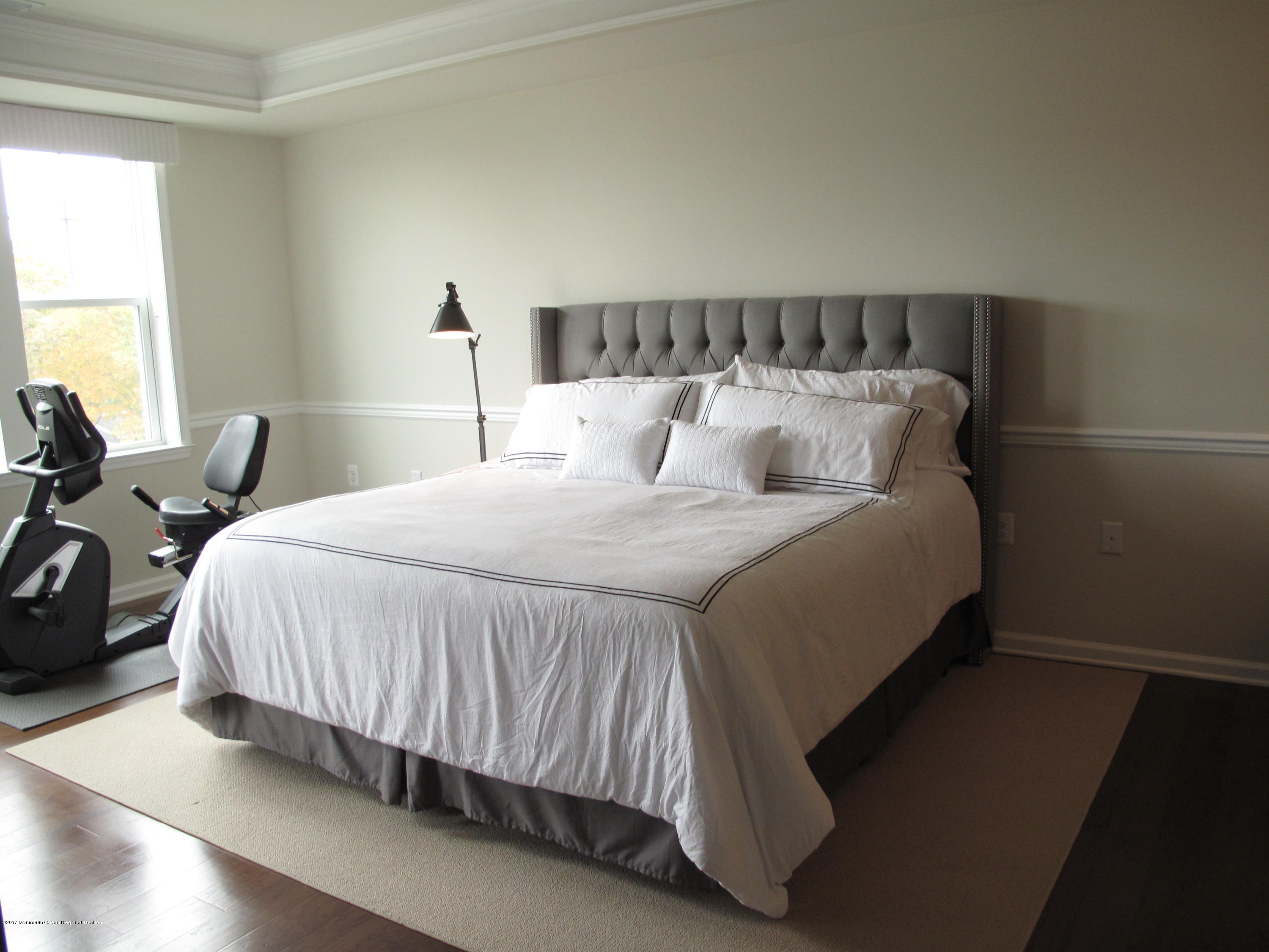 2201 River Road, Unit 4304 Point Pleasant, NJ 08742 - Photo 12 of 30 a bed sitting in a bedroom next to a window