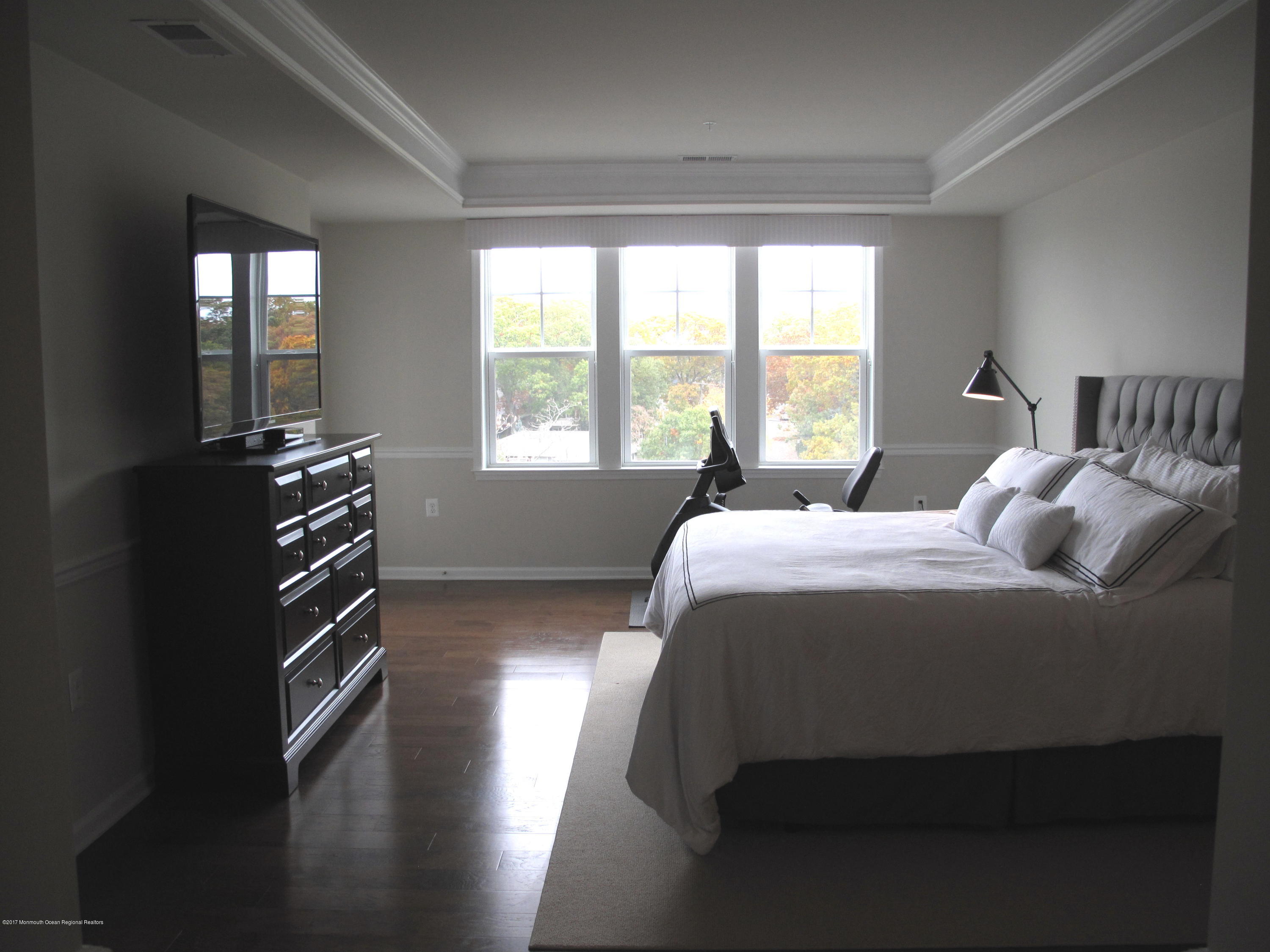 2201 River Road, Unit 4304 Point Pleasant, NJ 08742 - Photo 13 of 30 a bedroom with a bed and a large window