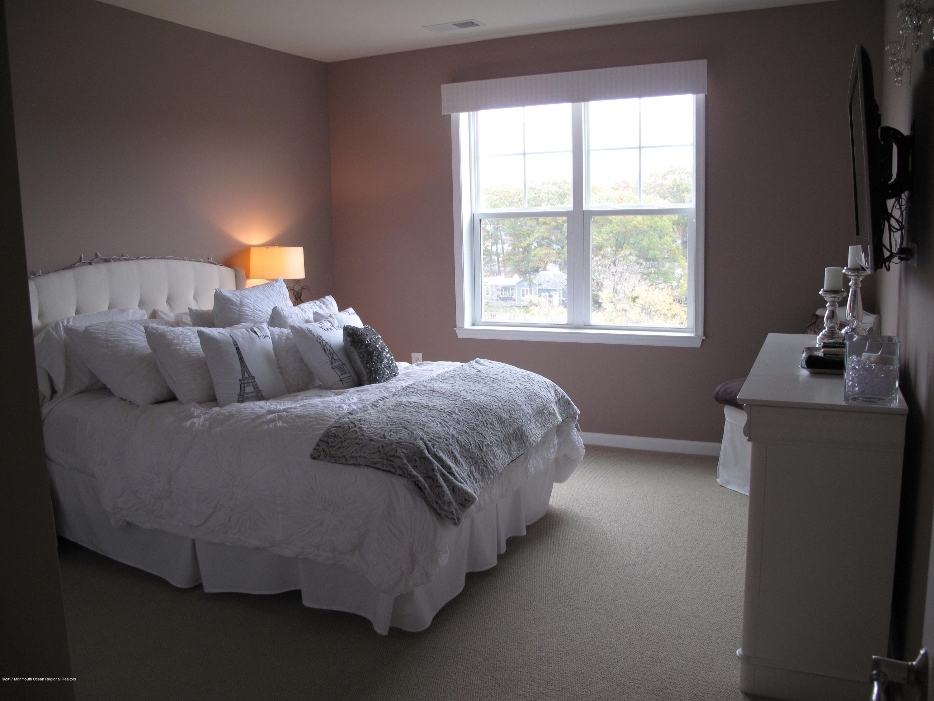2201 River Road, Unit 4304 Point Pleasant, NJ 08742 - Photo 17 of 30 a bedroom with a bed and a window