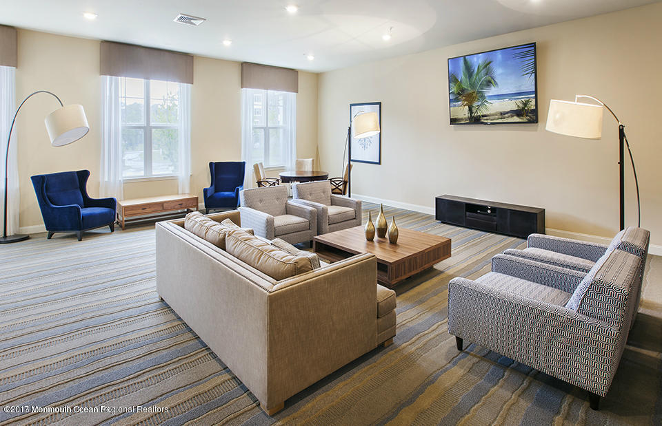 2201 River Road, Unit 4304 Point Pleasant, NJ 08742 - Photo 23 of 30 a living room with furniture and a fireplace