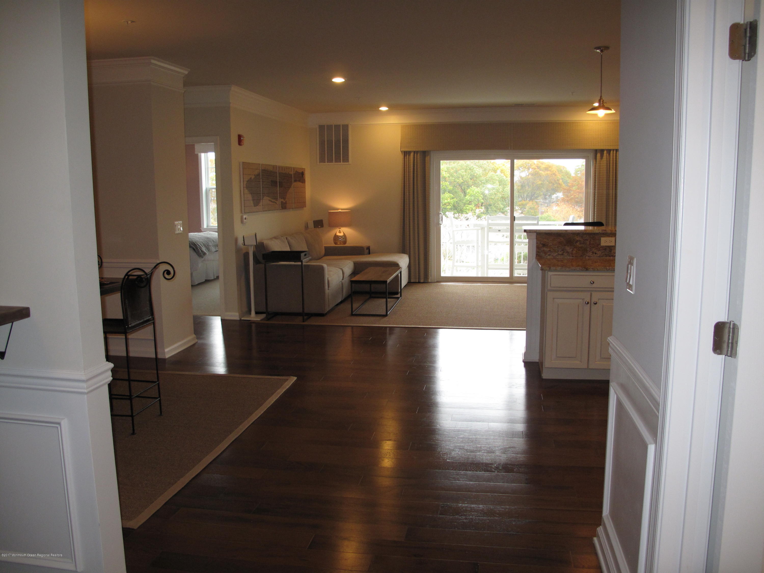 2201 River Road, Unit 4304 Point Pleasant, NJ 08742 - Photo 3 of 30 a view of a living room with wooden floor and a large window