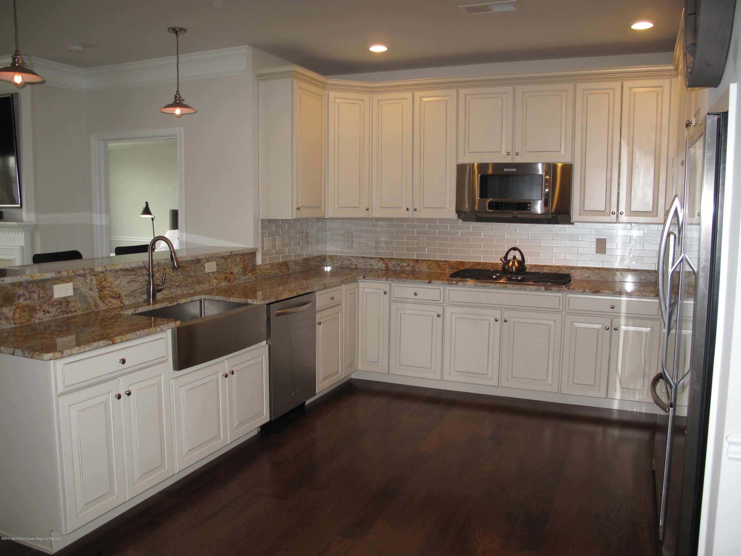 2201 River Road, Unit 4304 Point Pleasant, NJ 08742 - Photo 4 of 30 a kitchen with sink cabinets and microwave