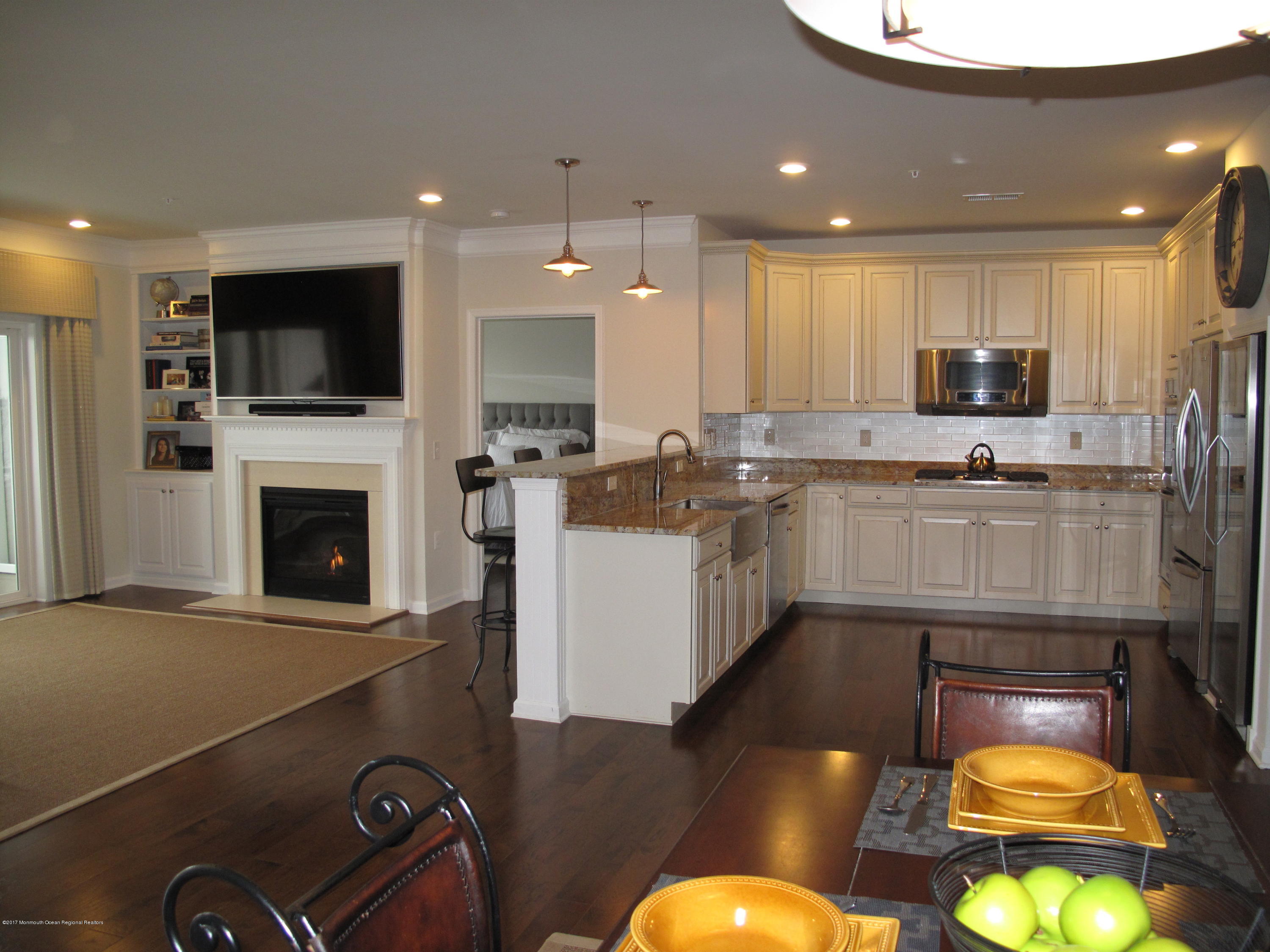 2201 River Road, Unit 4304 Point Pleasant, NJ 08742 - Photo 6 of 30 a kitchen with a stove a sink and a microwave