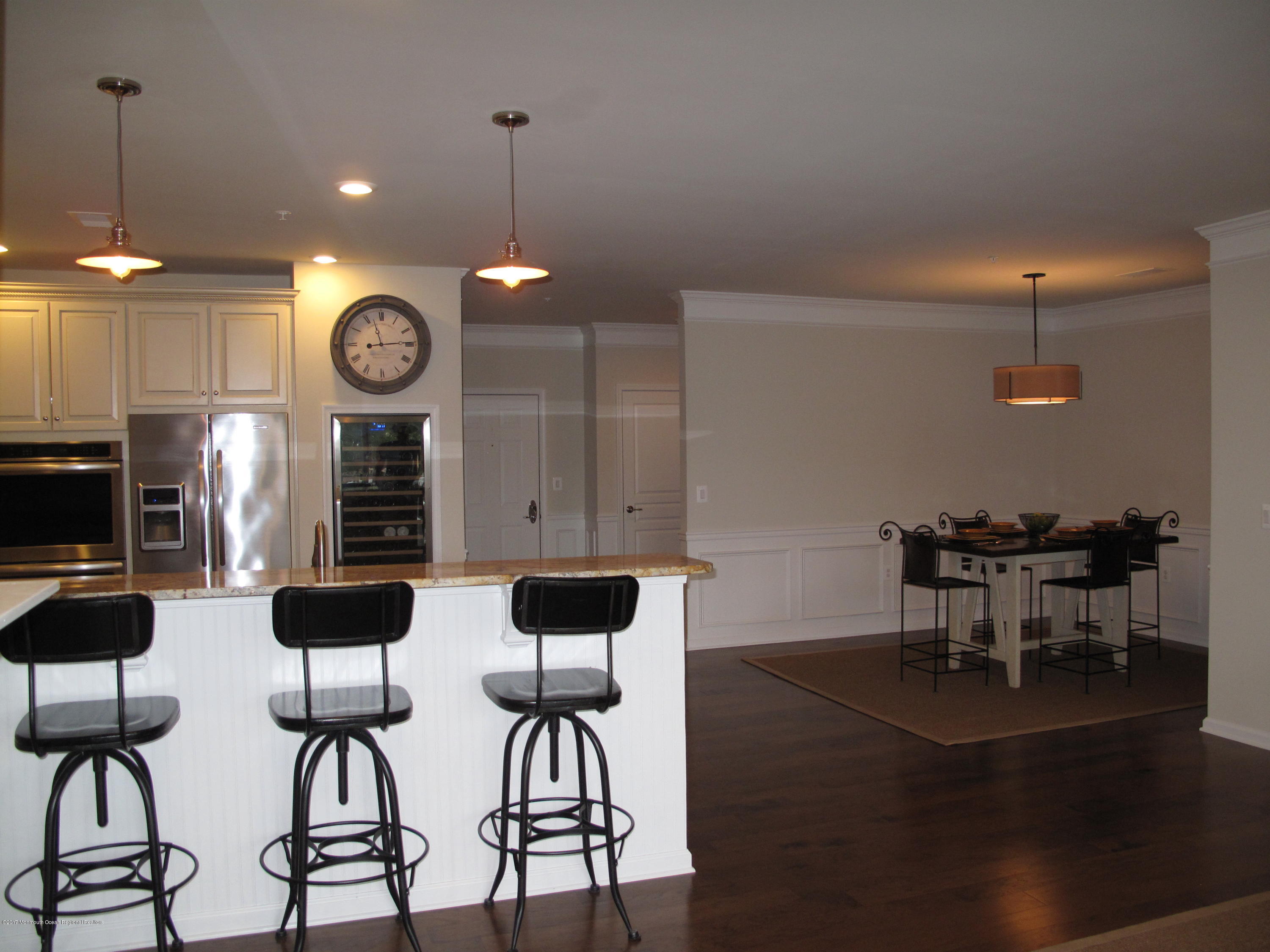 2201 River Road, Unit 4304 Point Pleasant, NJ 08742 - Photo 7 of 30 a kitchen with a dining table and chairs