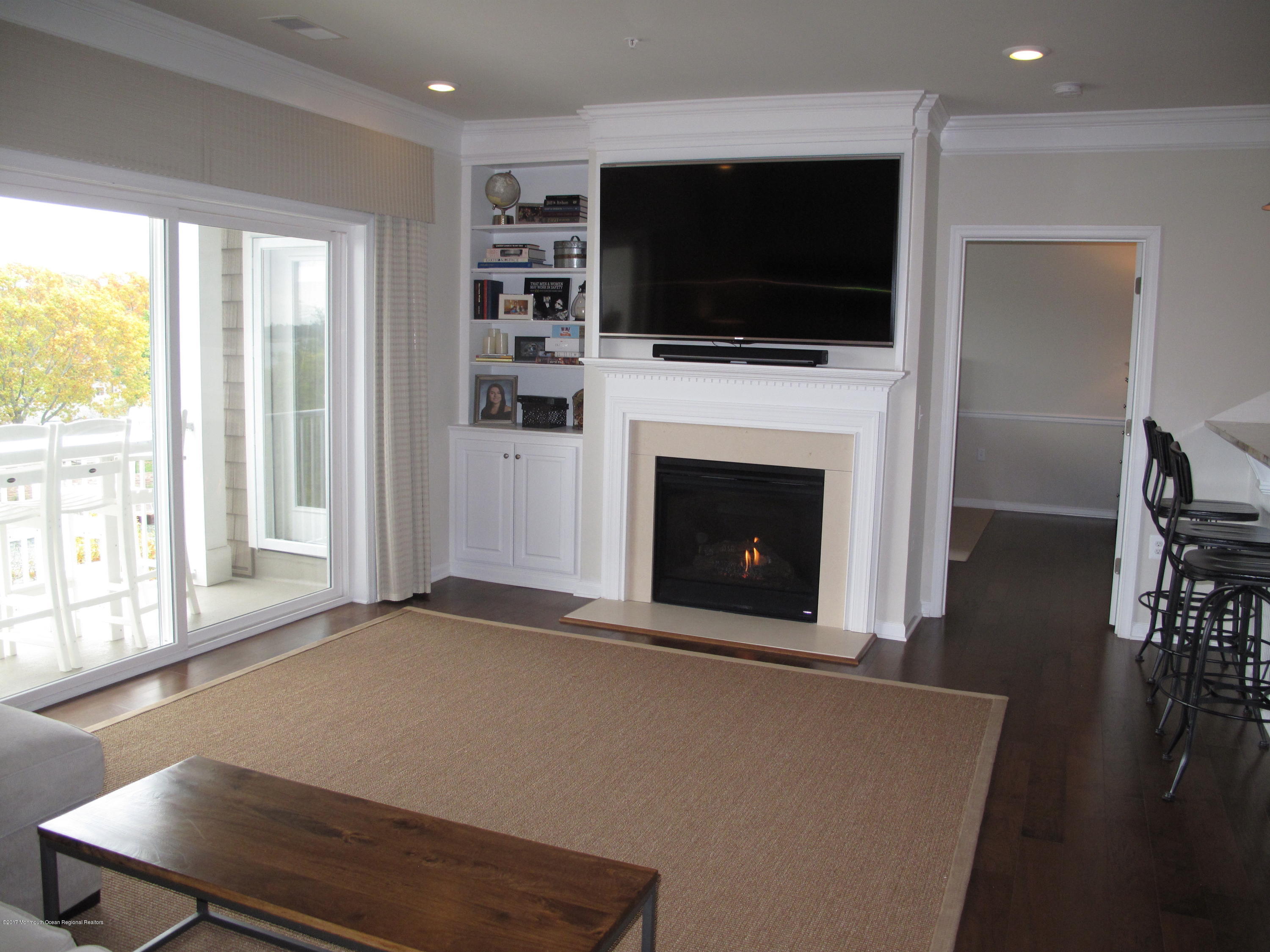 2201 River Road, Unit 4304 Point Pleasant, NJ 08742 - Photo 8 of 30 a living room with a flat screen tv and a fireplace